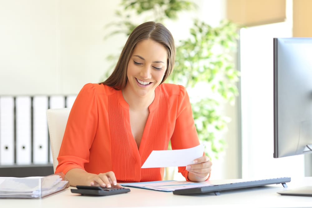 Businesswoman,Wearing,Orange,Blouse,Doing,Accounting,And,Calculating,With,A