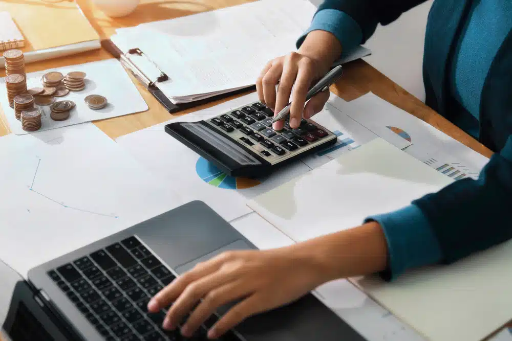 Woman,Accountant,Use,Calculator,And,Computer,On,Desk,In,Office. accounting jobs